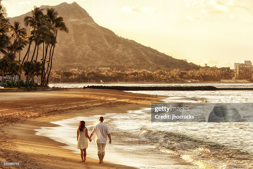 Happy Couple Walking on Waikiki Beach at Sunrise