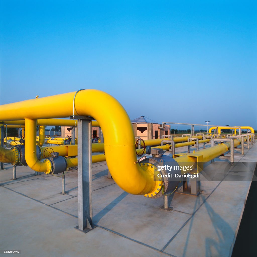 Yellow pipes in a gas distribution station, blue sky background