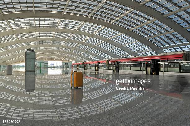 lonely suitcase and red train in beijing airport - beijing capital international airport stock pictures, royalty-free photos & images
