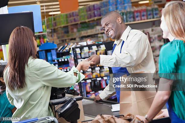 Handing Item 103 Cashier Handing Receipt To Customer Stock Photos, High-Res Pictures ...