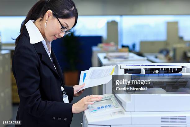 making copies - by the photocopier stockfoto's en -beelden