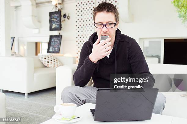 journalist with laptop and dictaphone - dictaphone stock pictures, royalty-free photos & images