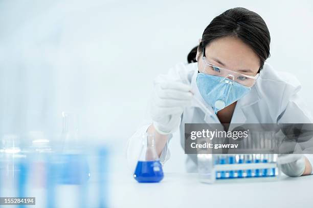 asian woman scientist working with chemical wearing protective workwear - provrörshållare bildbanksfoton och bilder
