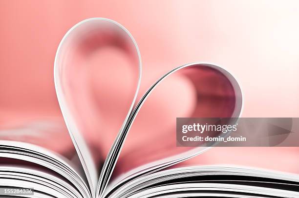 love to read, pages folded into heart shape, pink background - romance book stock pictures, royalty-free photos & images