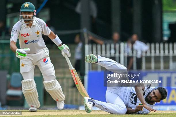 Sri Lanka's Asitha Fernando fields the ball as Pakistan's Babar Azam watches during the second day of the second and final cricket Test match between...