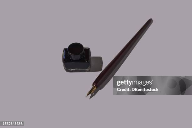 fountain pen and glass inkwell with black ink on a gray background. concept of writing, mail, retro, vintage, scriptwriter, writer, creativity, imagination, editorial and book. - pena de escrever imagens e fotografias de stock