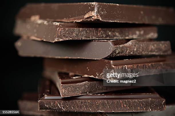 a close-up of a stack of dark chocolate - chocolate stockfoto's en -beelden