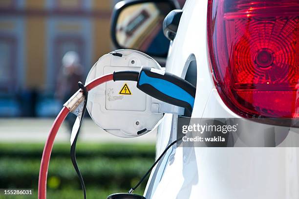 charge white electric car - genetic modification stock pictures, royalty-free photos & images