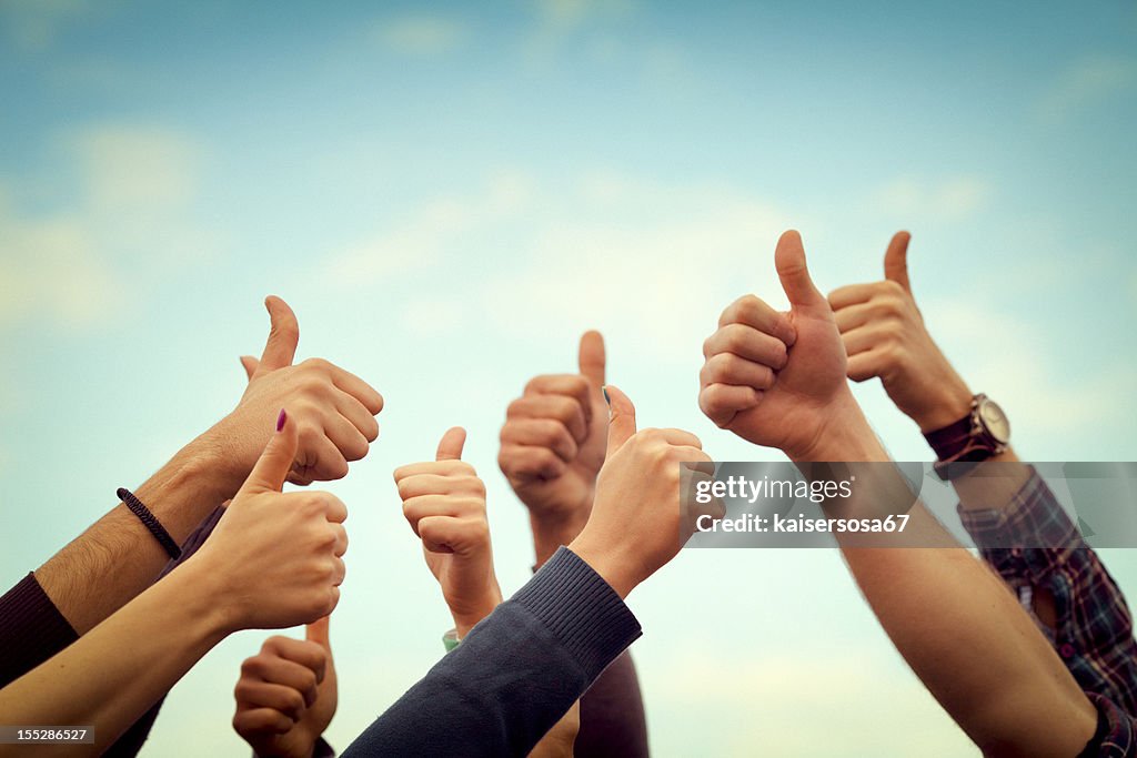 Group of people thumb up on the sky
