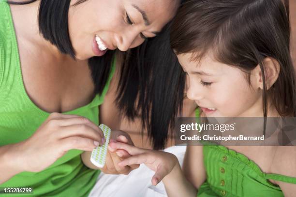 mother and daughter doing nail file - nail file stock pictures, royalty-free photos & images