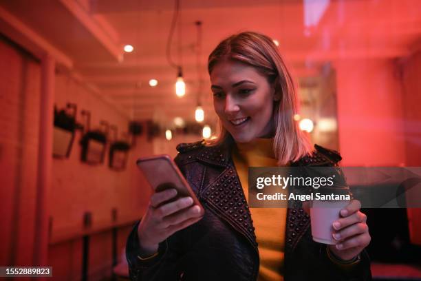stylish woman multitasking with coffee and smartphone - restuarant stock pictures, royalty-free photos & images