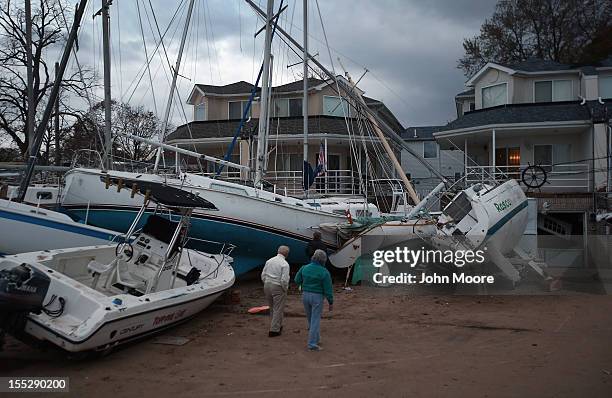 Boats pushed up by Hurricane Sandy sit against residences near a marina on November 2, 2012 in the Staten Island borough of New York City. Hundreds...