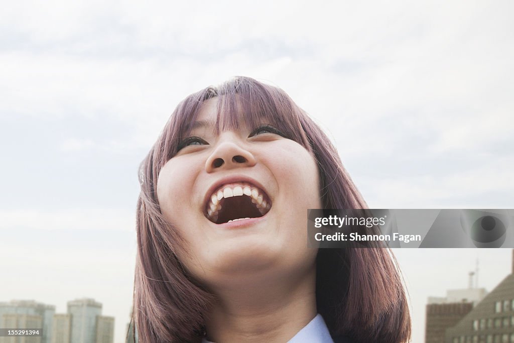Young Women Laughing with Cityscape