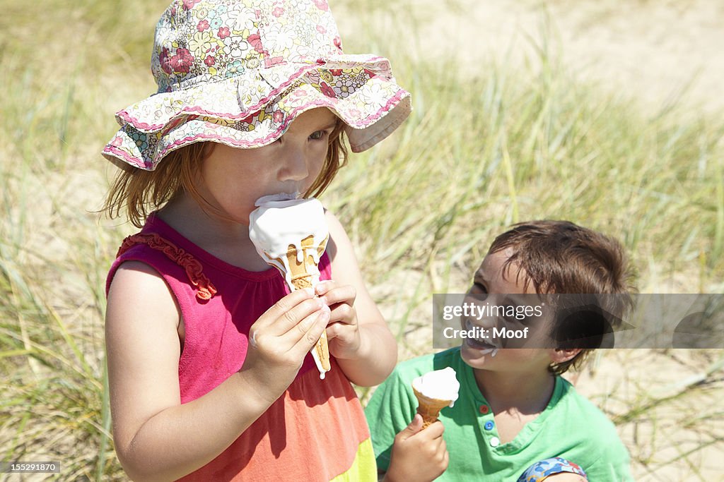 Children eating ice cream on beach