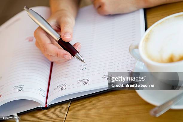 close up of woman writing in planner - 2012 calendar stock pictures, royalty-free photos & images