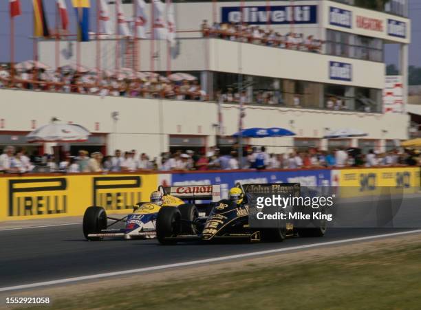 Ayrton Senna from Brazil driving the John Player Special Team Lotus-Renault 98T Renault V6 and Nigel Mansell from Great Britain driving the Canon...