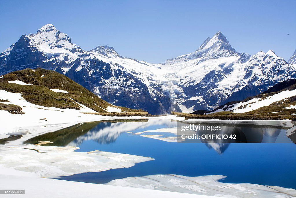 Snowy landscape reflected in still lake