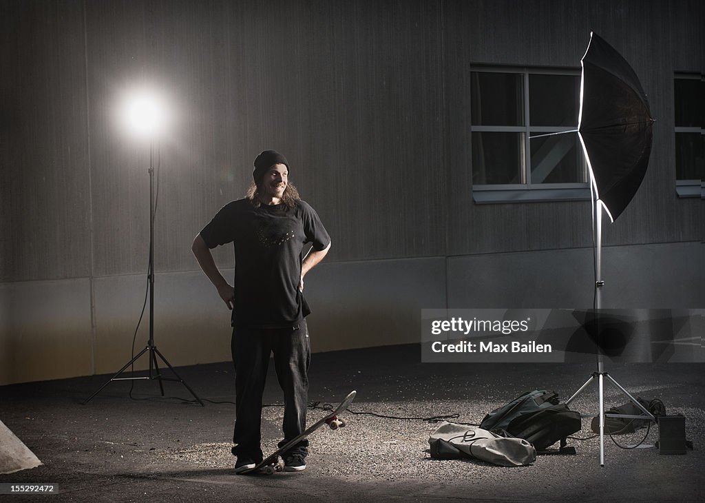 Skater standing under photo lights