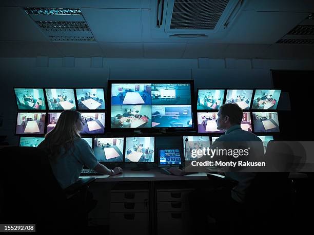 students watching screens in forensics training facility - bewakingscamera stockfoto's en -beelden