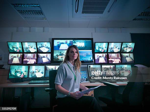 portrait of student with screens in forensics training facility - 管制室 ストックフォトと画像