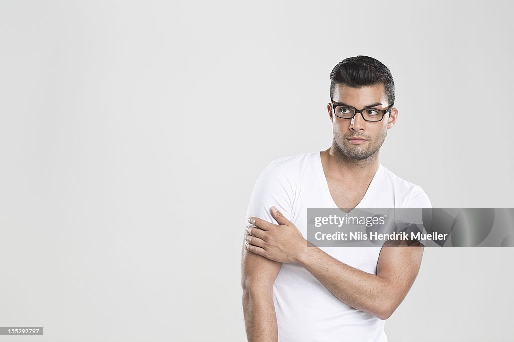 Curious man holding arm