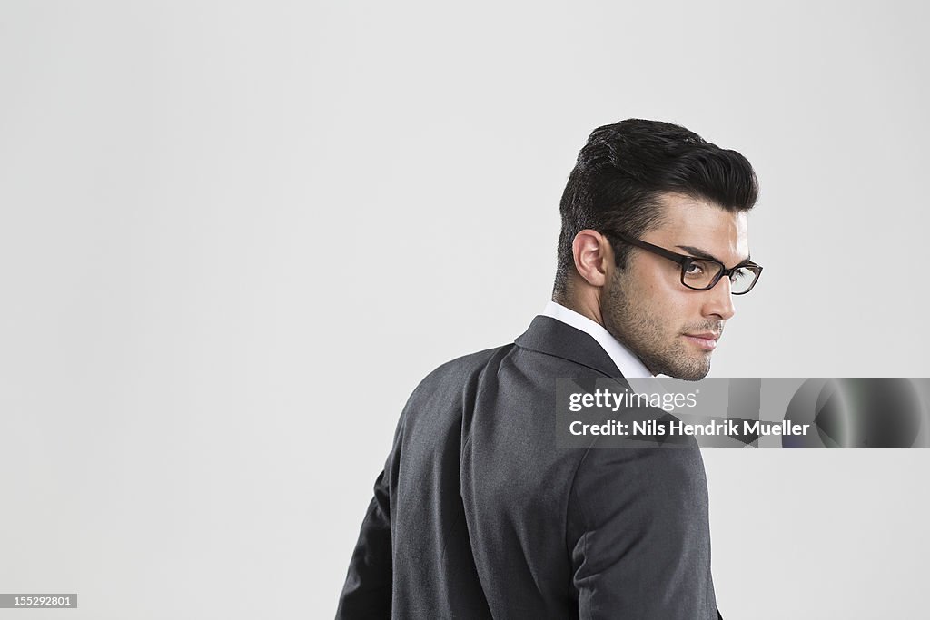 Businessman looking over his shoulder