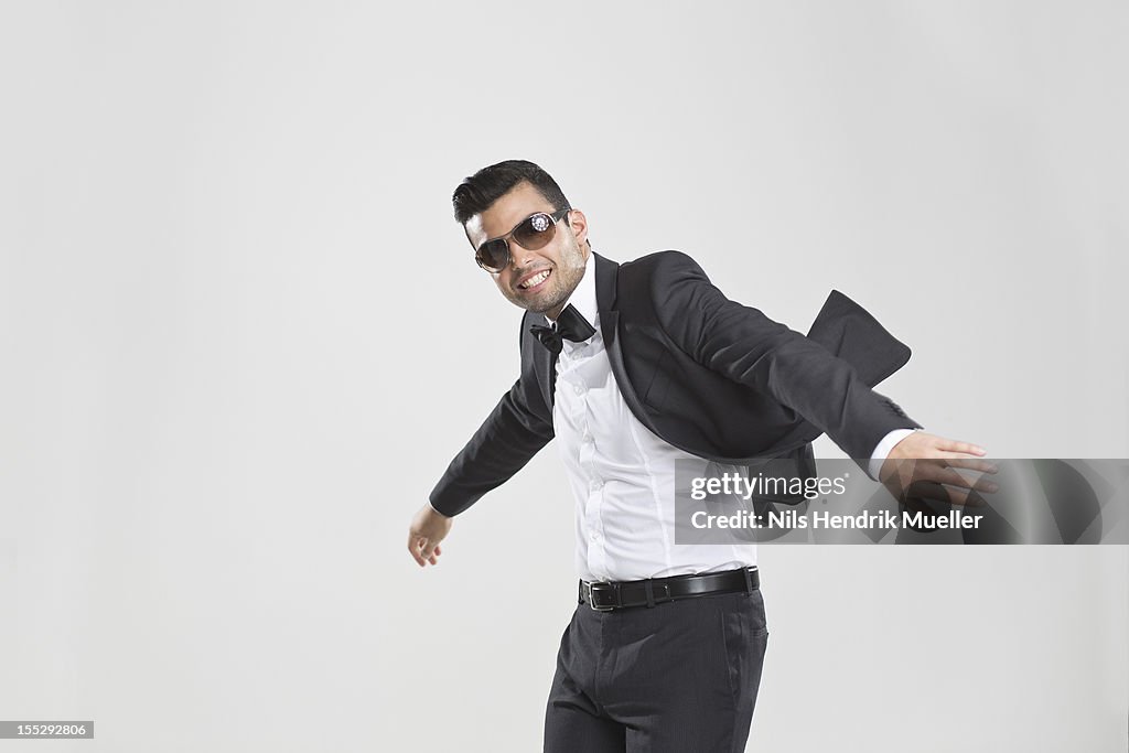 Smiling man in tuxedo dancing