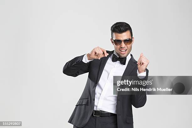 smiling man in tuxedo dancing - esmoquin fotografías e imágenes de stock