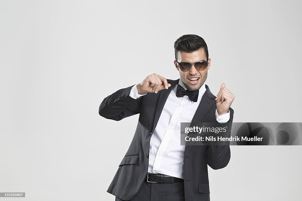 Smiling man in tuxedo dancing