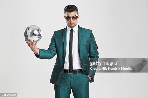 businessman holding disco ball - holding sunglasses stockfoto's en -beelden