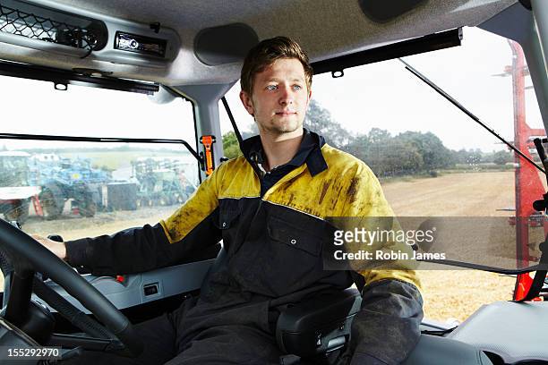 farmer driving tractor in field - agriculteur conducteur tracteur photos et images de collection