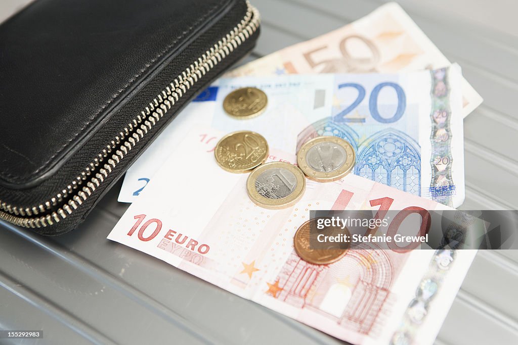 Wallet with euro notes and coins