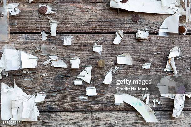 detail of staples, thumbtacks and ripped paper on a wooden wall - bulletin board flyer stock pictures, royalty-free photos & images