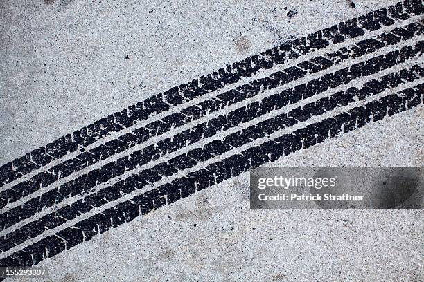 detail of a tire mark on concrete - rastro fotografías e imágenes de stock