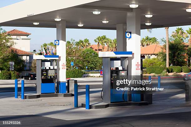 fuel pumps at a gas station - benzinestation stockfoto's en -beelden