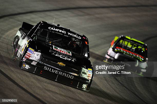 Nelson Piquet Jr., driver of the TAG Heuer Avant-Garde Eyewear Chevrolet, leads Johnny Sauter, driver of the SealMaster/Curb Records Toyota, during...