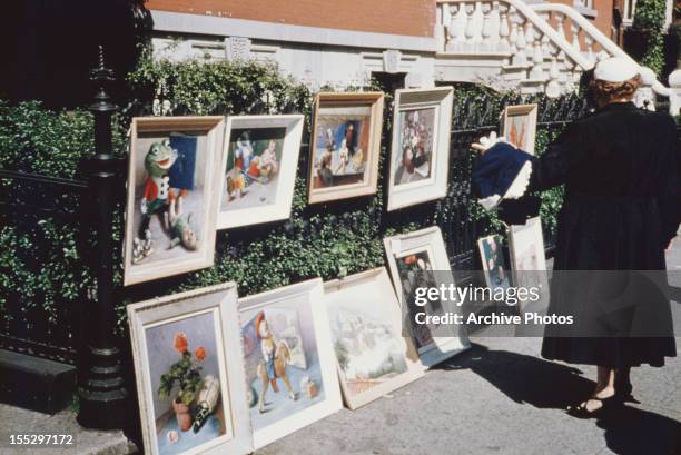 Paintings on display on the sidewalk in Greenwich Village, New York City, circa 1960.