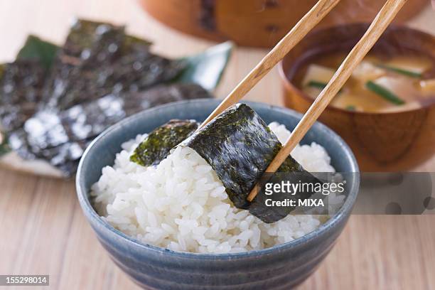 nori on steamed rice - rice bowl stock pictures, royalty-free photos & images