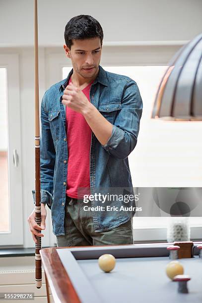 man looking at a pool table - cue stock pictures, royalty-free photos & images