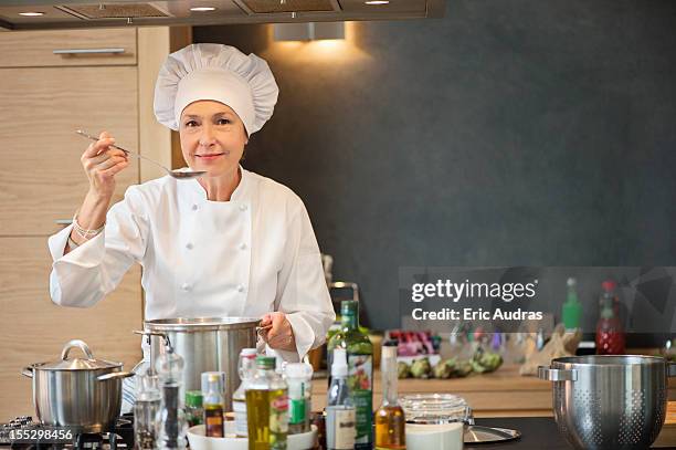 woman tasting food - chef hat stock pictures, royalty-free photos & images