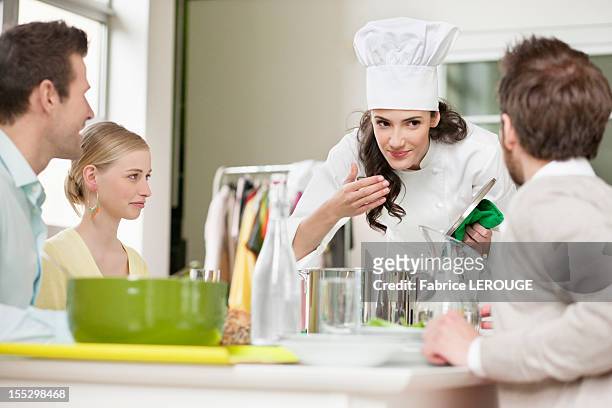 female chef smelling food before serving - chef smelling food stockfoto's en -beelden