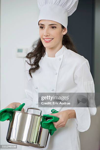 woman carrying a saucepan - holding saucepan stock pictures, royalty-free photos & images