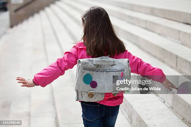 rear view of a girl walking on the steps - sac à dos enfant photos et images de collection