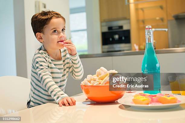 boy eating snack - child standing stock pictures, royalty-free photos & images