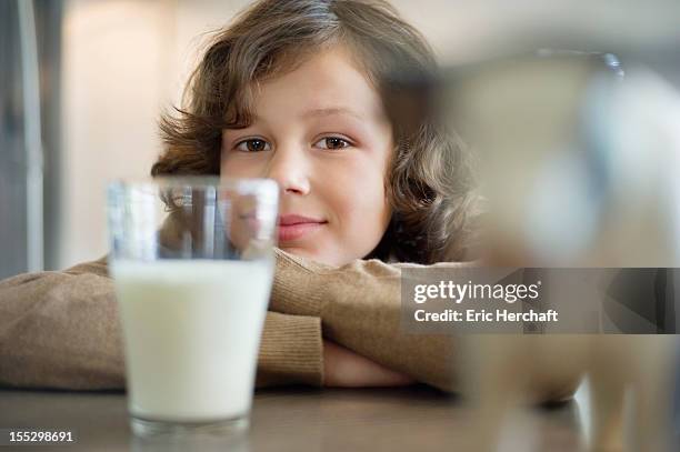 portrait of a boy with a glass of milk - table only close up stock pictures, royalty-free photos & images
