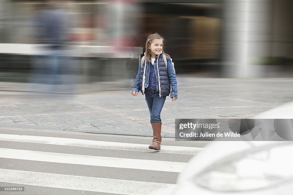 Schoolgirl crossing a road