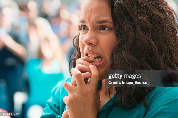 tense female spectator - nail biting stock pictures, royalty-free photos & images