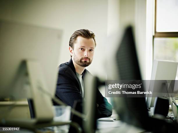 businessman at workstation in front of computer - dedication background stock pictures, royalty-free photos & images