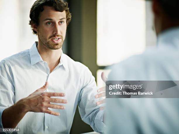 businessman in discussion with coworker in office - button down shirt close up stock pictures, royalty-free photos & images