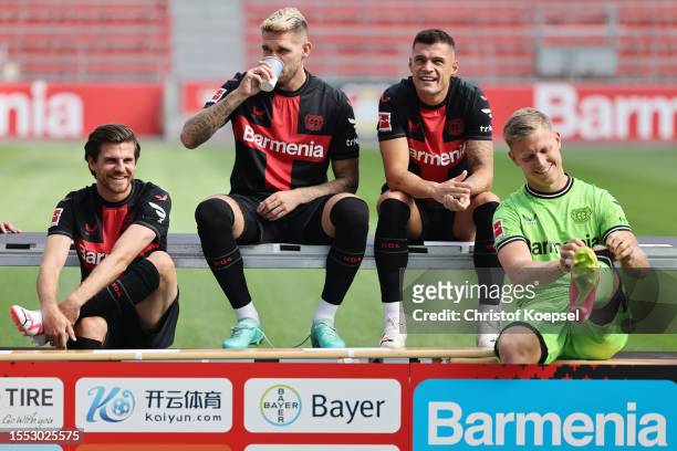 Jonas Hofmann, Robert Andrich and Granit Xhaka of Bayer Leverkusen pose during the team presentation at BayArena on July 18, 2023 in Leverkusen,...